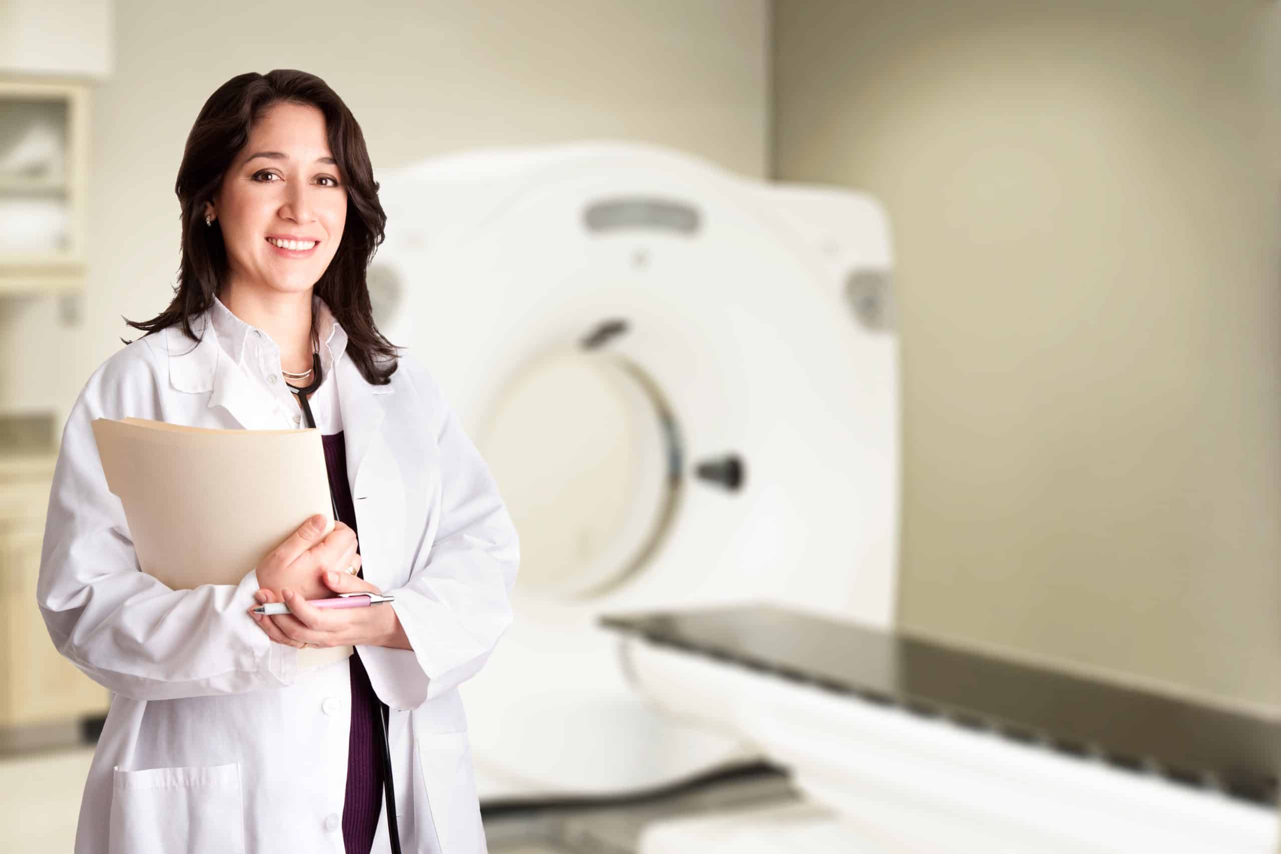 Female doctor radiologist at CT CAT scan with chart