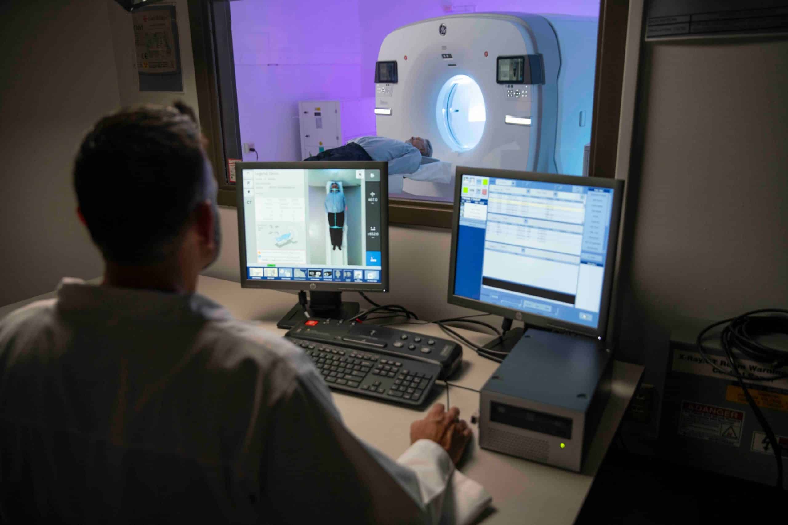 Doctor working with patient in Omni Legend PET/CT scanner