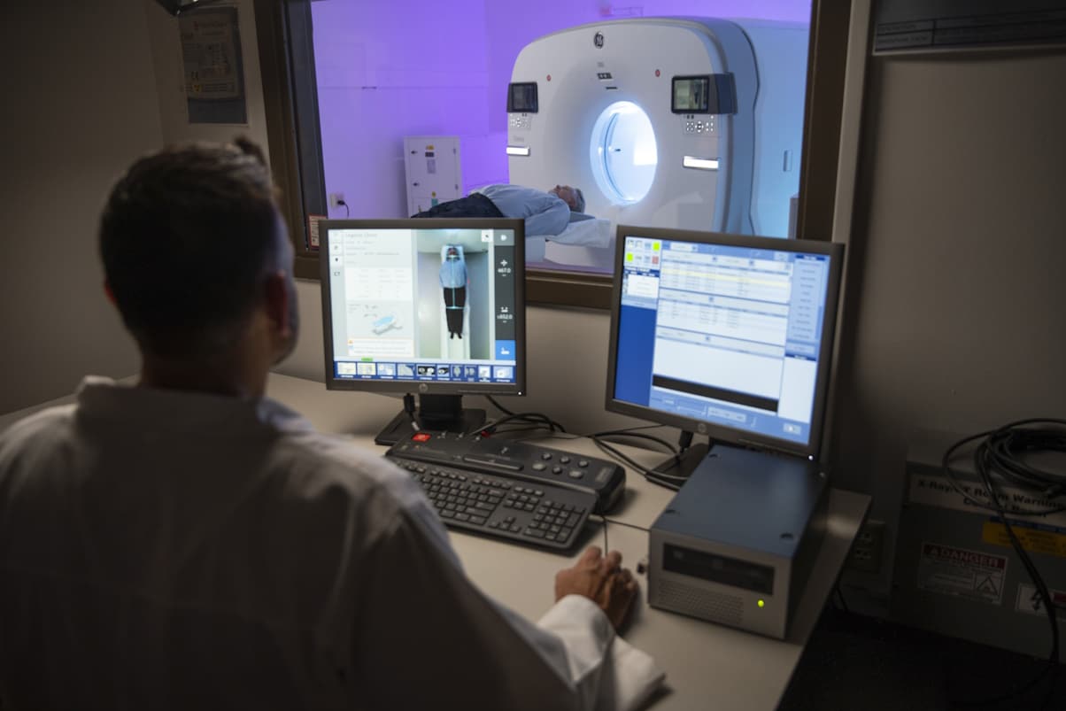 Doctor working, patient in scanner